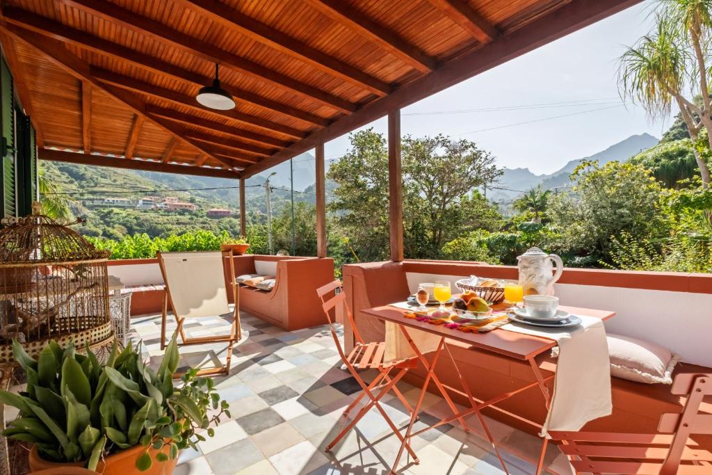 a patio with a table and chairs with a view at Casa Grande da Camélia in São Vicente
