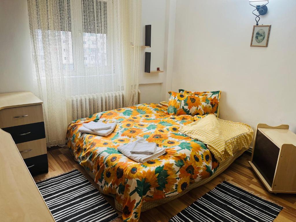 a small bedroom with a bed and a window at Apartament Cornelia in Buzău