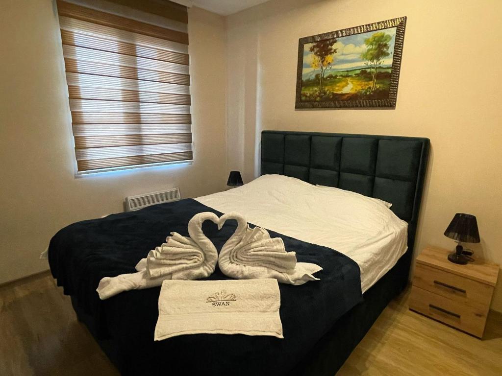 Postel nebo postele na pokoji v ubytování Swan Apartman