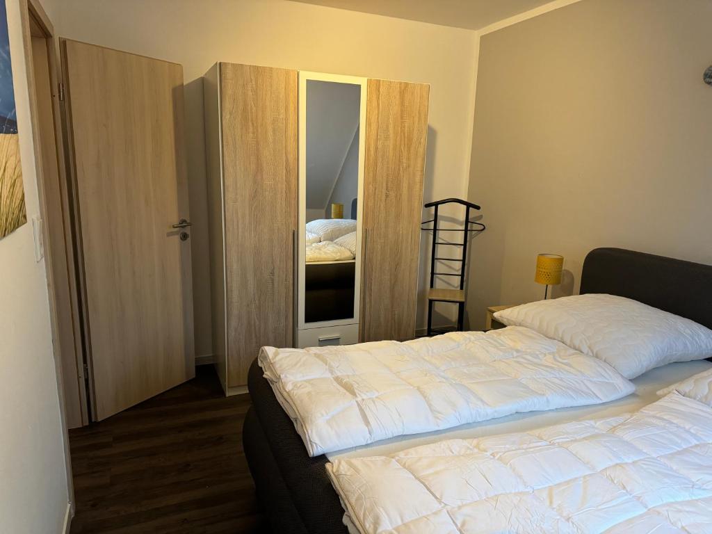 a bedroom with a bed and a ladder in it at Ferienwohnung Nebelhorn in Dagebüll in Dagebüll
