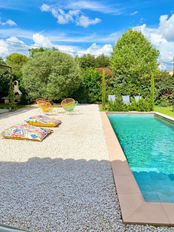 una piscina con due sedie a sdraio accanto alla piscina di villa Luberon a Saint-Saturnin-lès-Apt