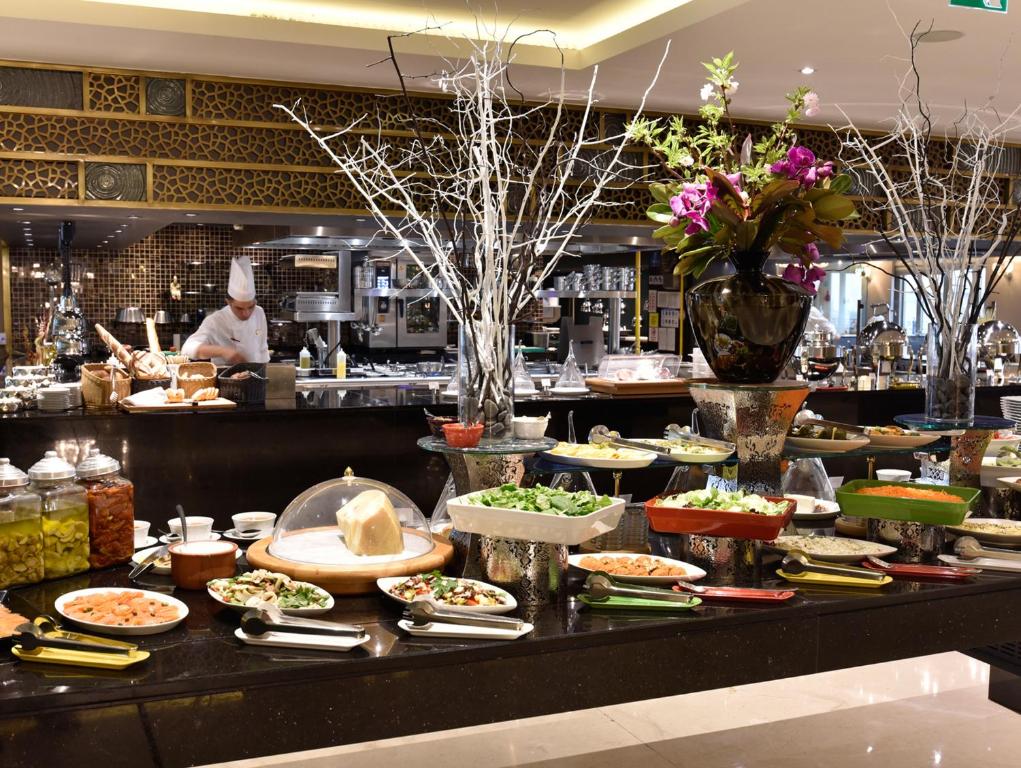 a buffet line with many different types of food at CVK Park Bosphorus Hotel Istanbul in Istanbul