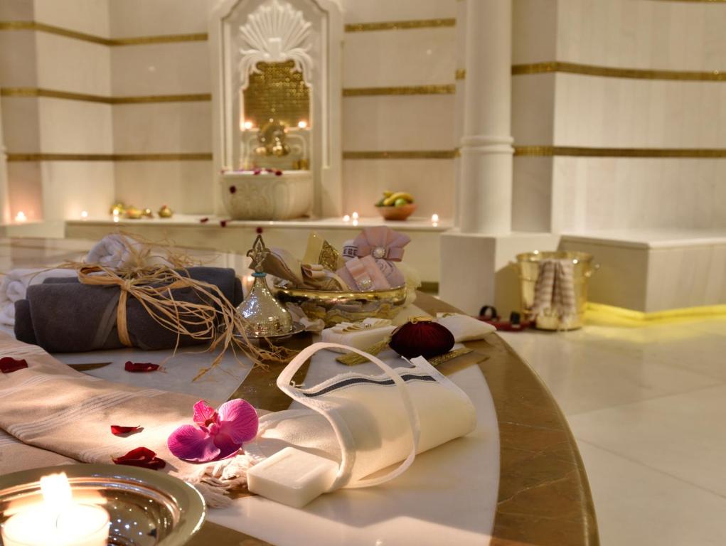 a room with a table with shoes and a candle at CVK Park Bosphorus Hotel Istanbul in Istanbul