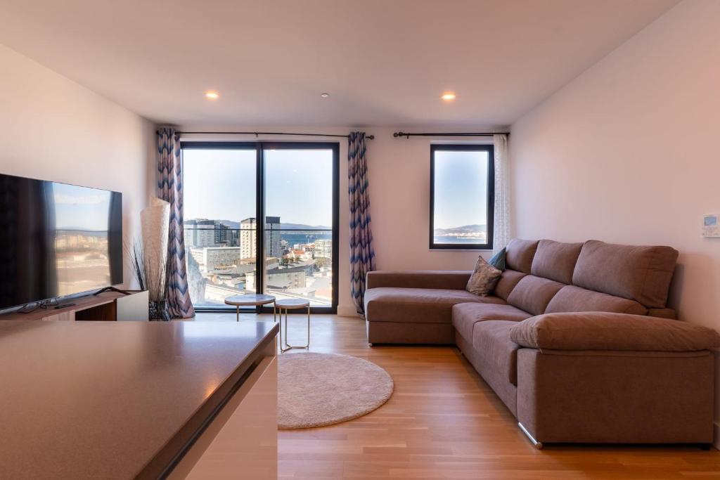 a living room with a couch and a flat screen tv at FORBES Suite1206-Hosted by Sweetstay in Gibraltar