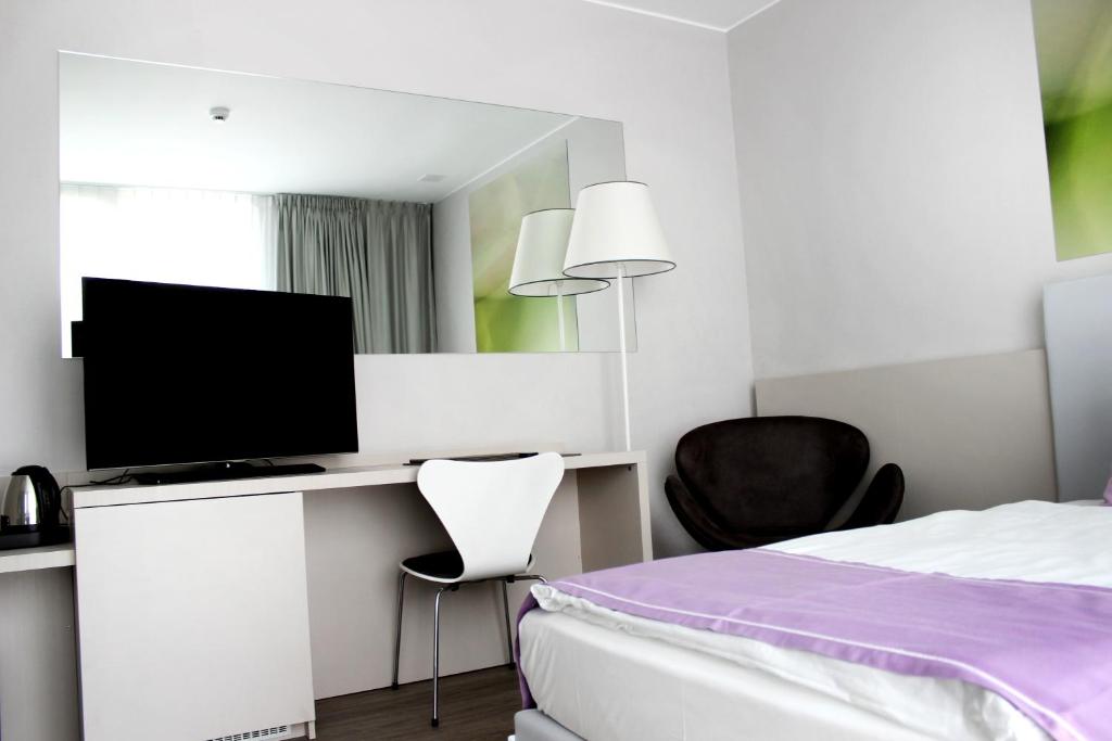 TV a/nebo společenská místnost v ubytování Hotel City Lugano
