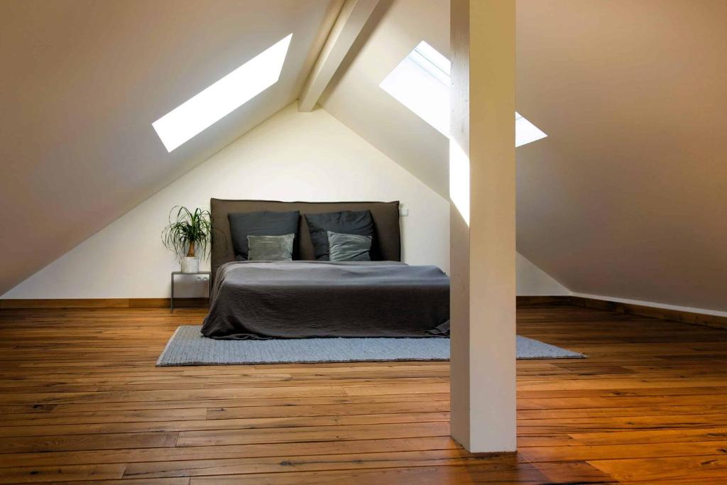 a bedroom with a bed in the attic with skylights at N6Quartier in Bad Münstereifel