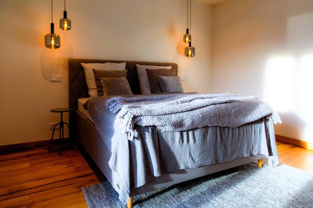 a bedroom with a large bed with a blue rug at N6Quartier in Bad Münstereifel