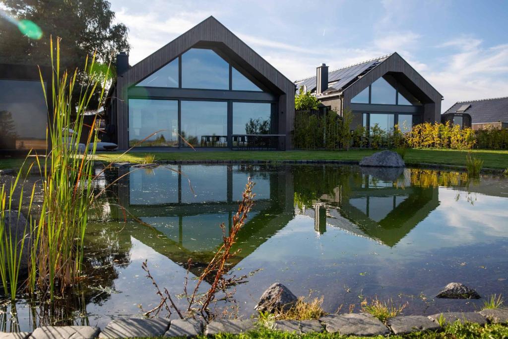 a house with a pond in front of it at N6Quartier in Bad Münstereifel