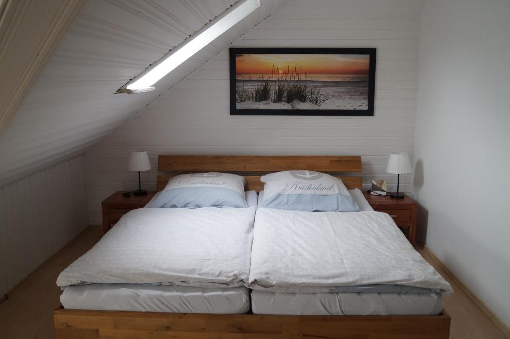a bedroom with a bed with two pillows at Ferienwohnung Robbe in Cuxhaven