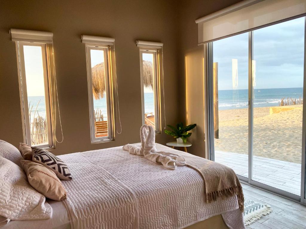 a bedroom with a bed with a view of the beach at Ribera Del Norte in Canoas