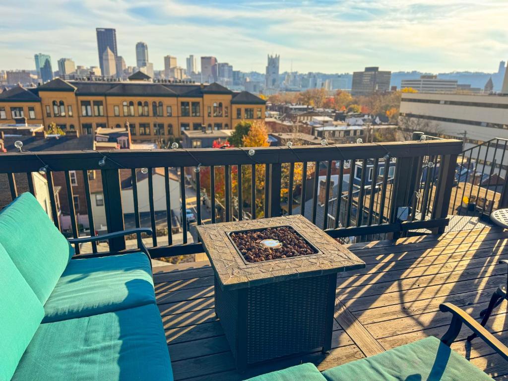 a balcony with a table and a view of a city at Steel City Getaway w/City View in Pittsburgh