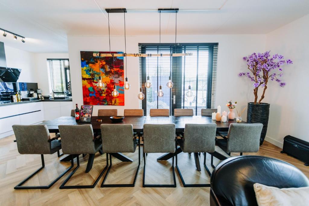 a dining room with a table and chairs at Dutch Design Villa with 6 luxurious bedrooms in Amsterdam