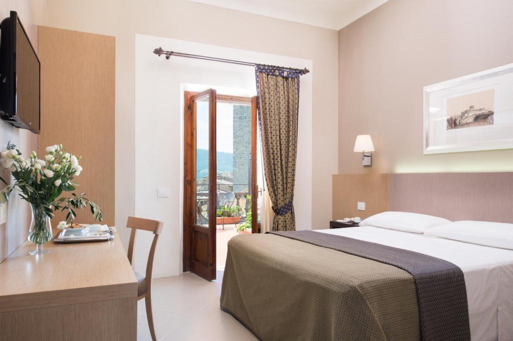 Postel nebo postele na pokoji v ubytování Hotel La Cisterna