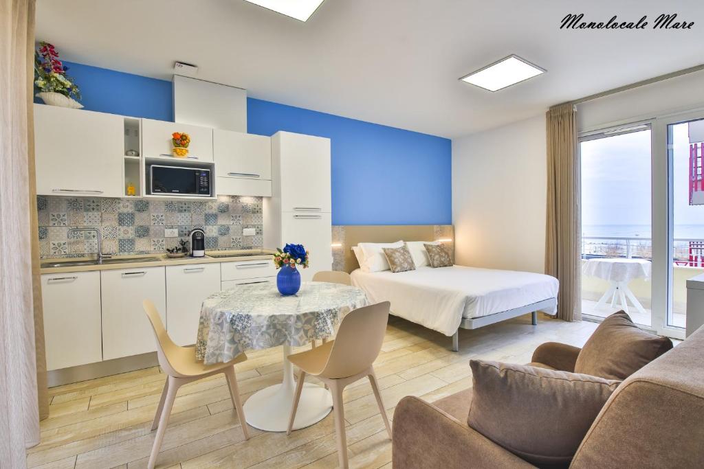 a kitchen and a living room with a table at Casa Stefania Rimini in Rimini