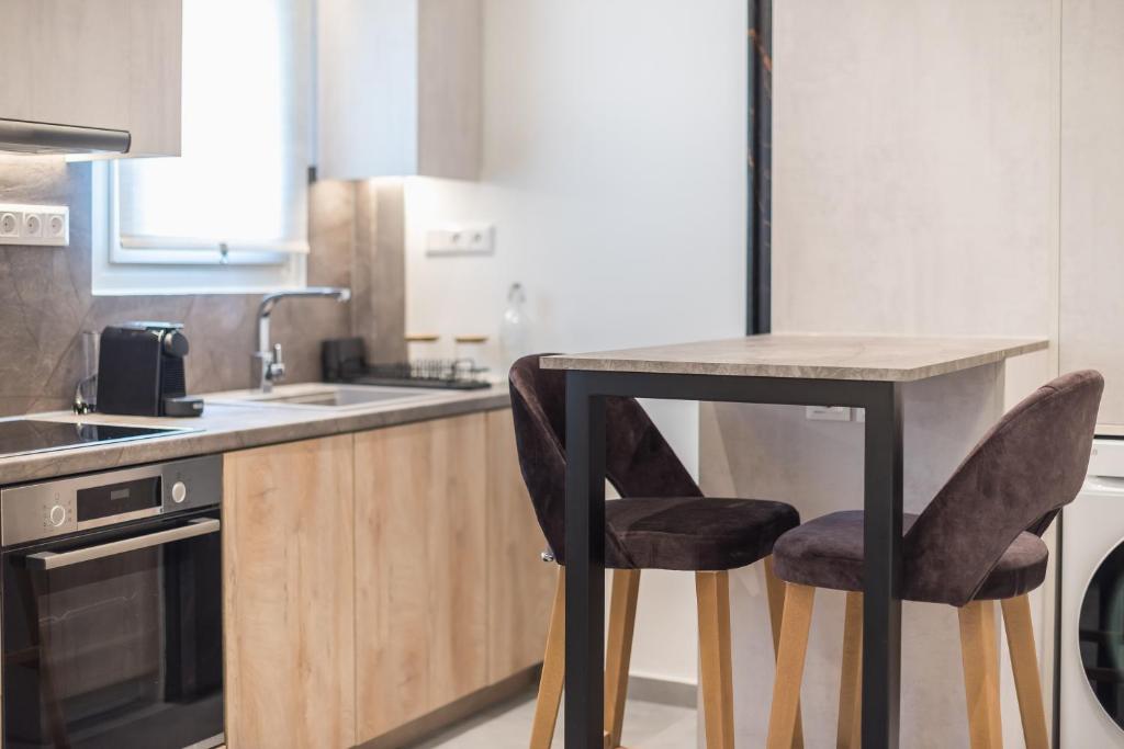 a kitchen with a table and two chairs at Newly Renovated Escape/Psychiko in Athens