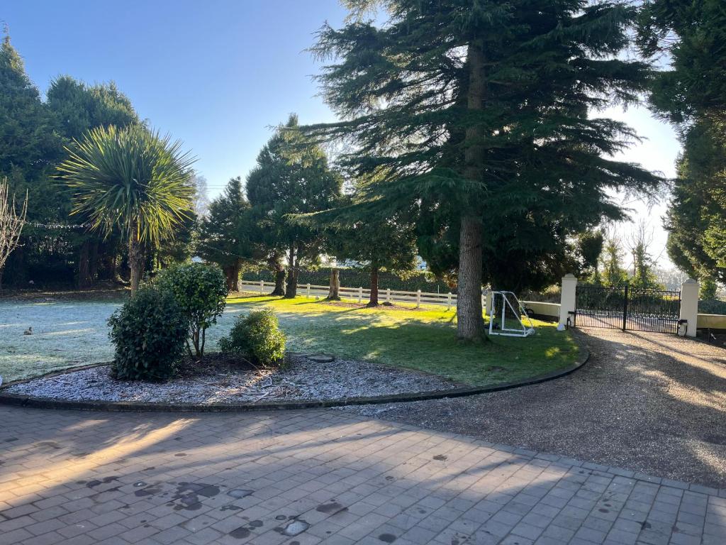 a park with a tree in the middle of a road at Country Retreat Near Emerald Park in Dunshaughlin