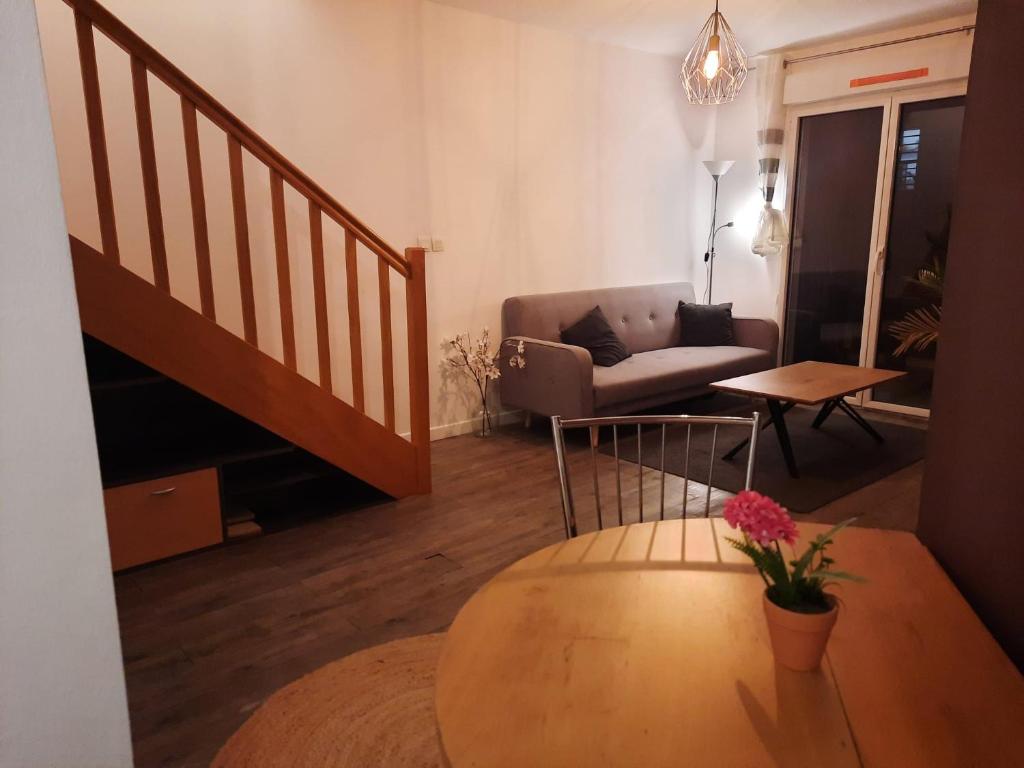 a living room with a couch and a table at La Chambre Saint Jacques &amp; Rennes in Saint-Jacques-de-la-Lande