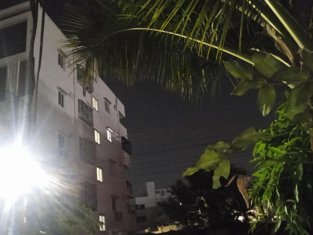 a tall building at night with the sun shining at Anantha in Secunderabad