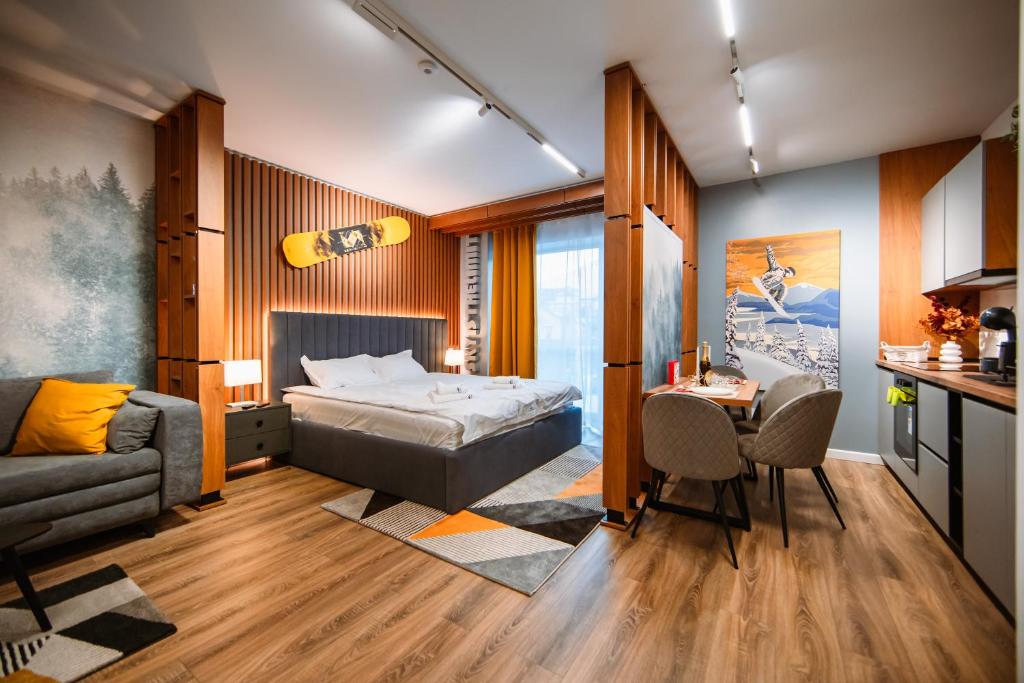 a bedroom with a bed and a table and a couch at Blue Sky Studio with pool and spa in Sinaia