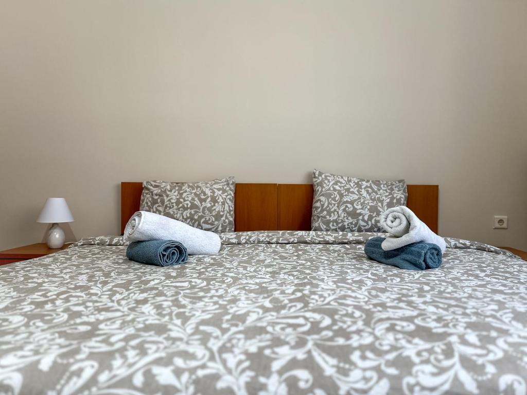 a bed with two towels and a stuffed animal on it at Faros Axd Odysseus Apartment in Alexandroupoli