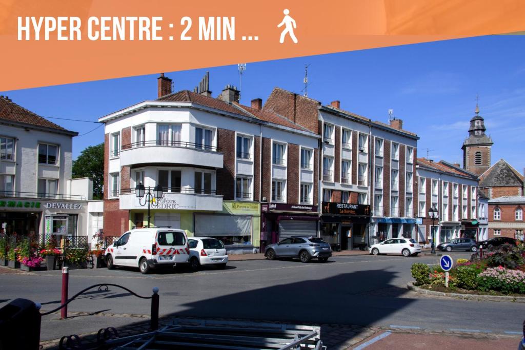 a city with cars parked on a street with buildings at La Domus Lemaitre 1, plain-pied, Wifi , TV, parking, jardin 