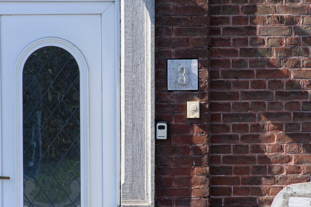 a door of a brick building with a number on it at La Domus Lemaitre 1, plain-pied, Wifi , TV, parking, jardin 