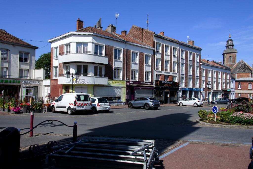a city street with cars parked in front of buildings at La Domus Lemaitre 1, plain-pied, Wifi , TV, parking, jardin 