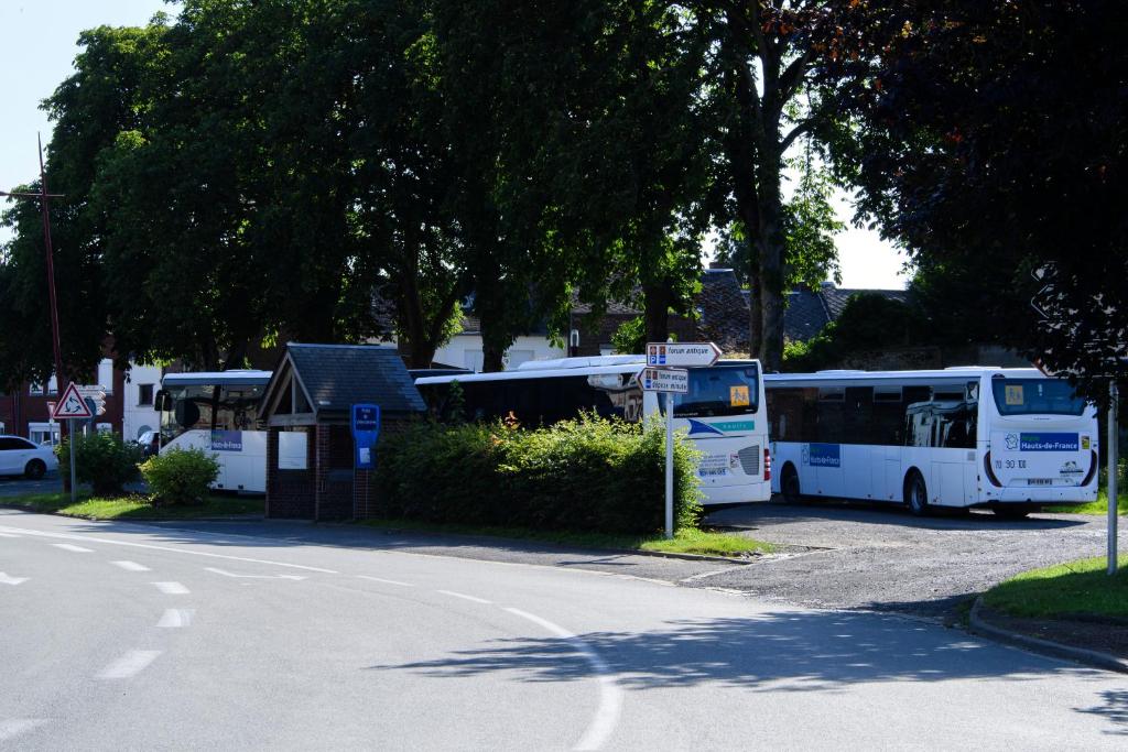 a group of buses parked in a parking lot at La Domus Lemaitre 1, plain-pied, Wifi , TV, parking, jardin 