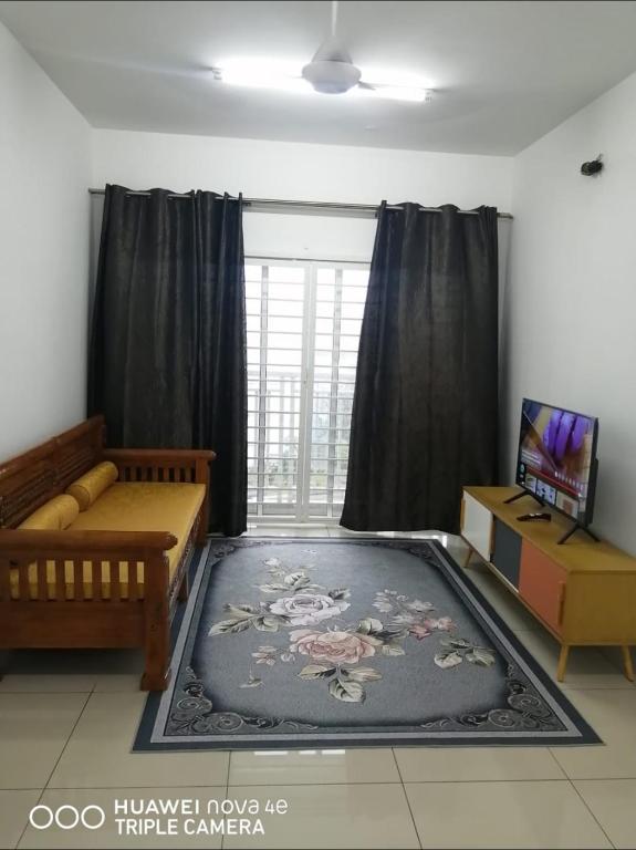 a living room with a couch and a large rug at Rizqi Homestay Seruling in Putrajaya