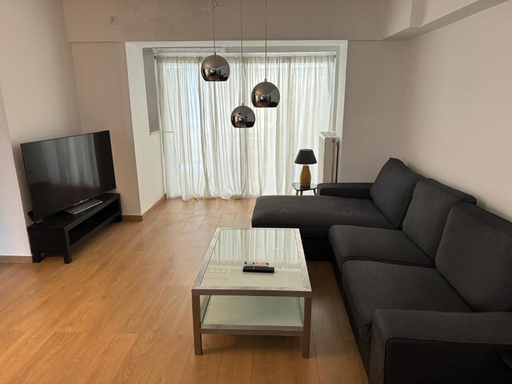 a living room with a couch and a coffee table at Athens Gate Acropolis One bedroom apartment in Athens