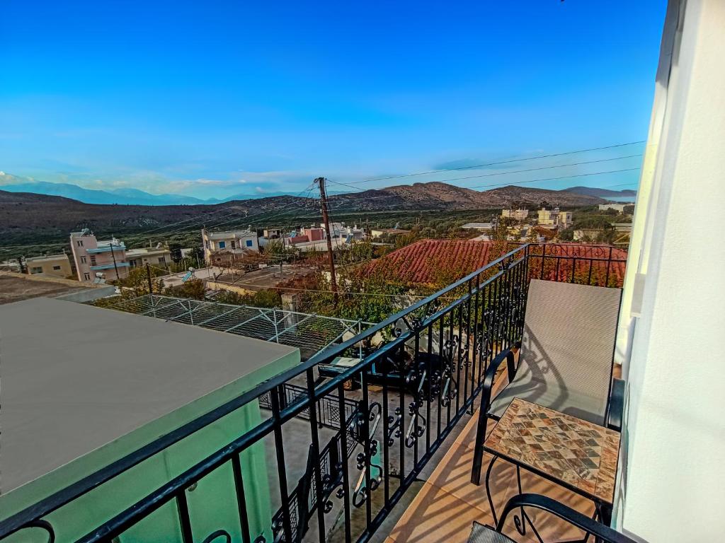 a balcony with a view of a city at Maisonette Kavousi with Mountain and Village View in Kavoúsion