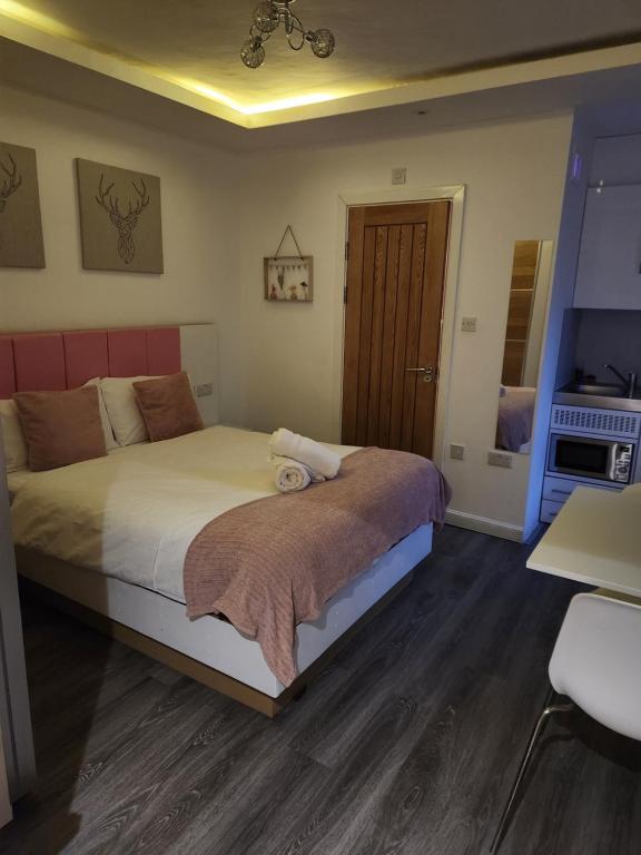 a bedroom with a bed and a table and a chair at Crosskeys Edinburgh in Edinburgh