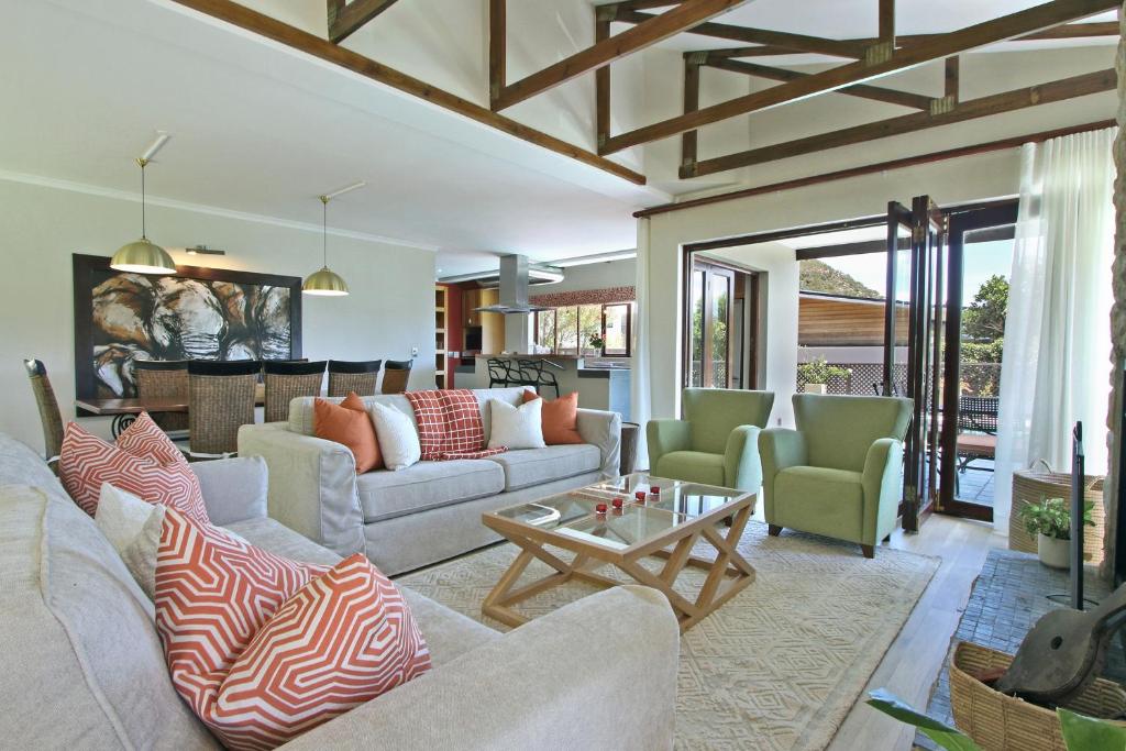 a living room with couches and chairs and a table at Villa Arena in Cape Town