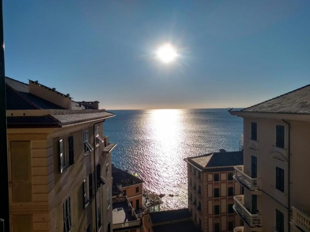 a view of the ocean from between buildings at Casa Teresina a Camogli in Camogli