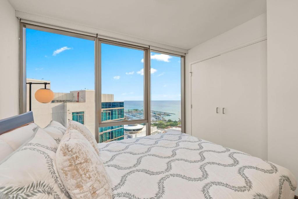 a bedroom with a bed with a view of the ocean at Sky Ala Moana 4209 condo in Honolulu