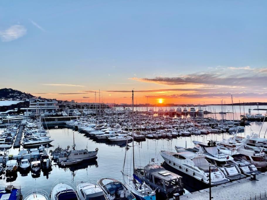 un groupe de bateaux amarrés dans une marina au coucher du soleil dans l'établissement Wow this view! 2BR facing Old Port 4th floor Olam Properties, à Cannes