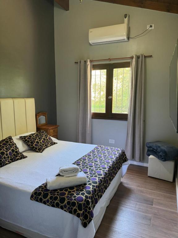 a bedroom with a bed and a window at Like at Home Ezeiza in Ezeiza