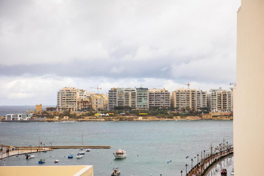 a view of a city with boats in the water at Chic 1BR Retreat in St Julian's in St Julian's