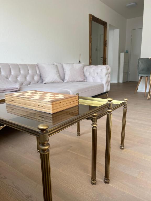a living room with a couch and a glass table at Best located & fully equipped apartment at Basel SBB main station in Basel