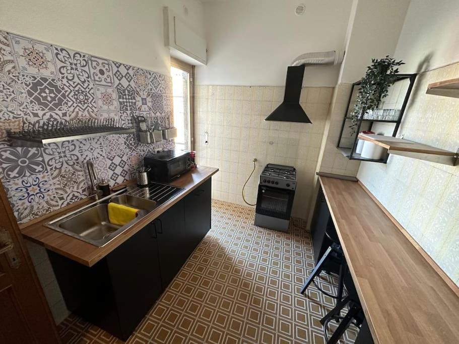 a small kitchen with a sink and a stove at [Metro C - Centocelle] Ampio Appartamento con tre camere da letto in Rome