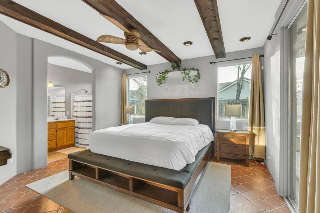 a bedroom with a large bed and a large window at Mediterranean Style Modern House in Sacramento