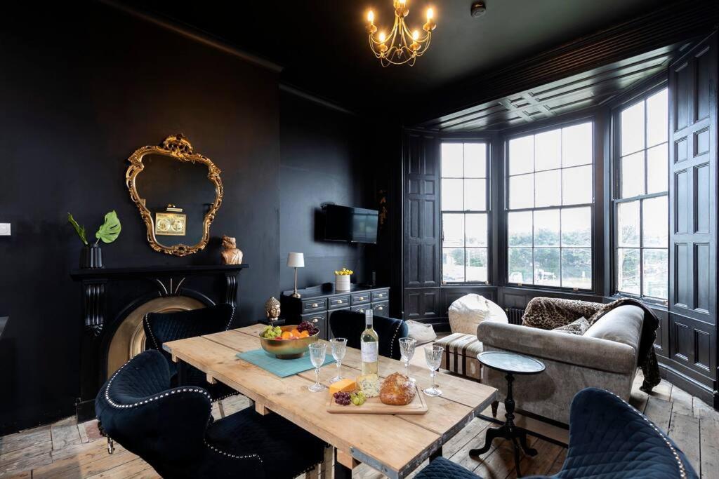 a living room with a wooden table and chairs at Dickens' Nook in Hartlepool