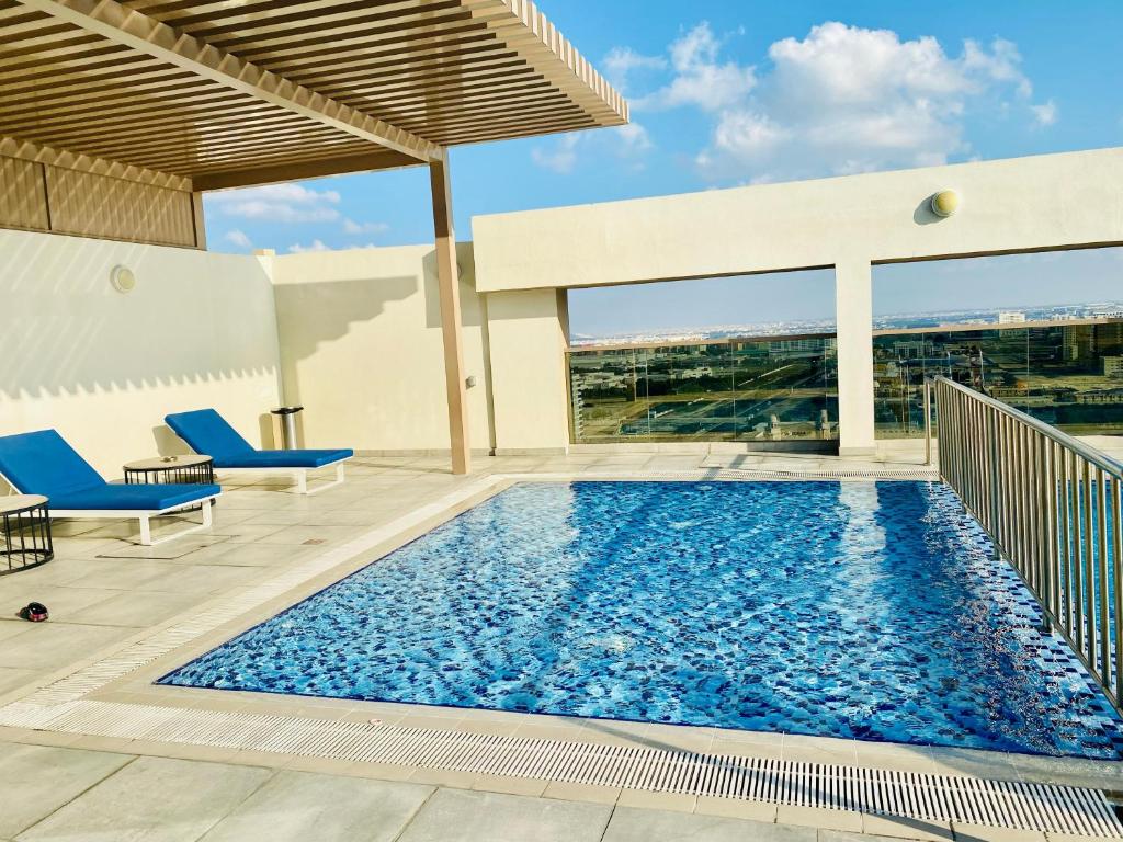 a swimming pool on the roof of a building at Executive Master Bedroom In Shared Apartment in Dubai