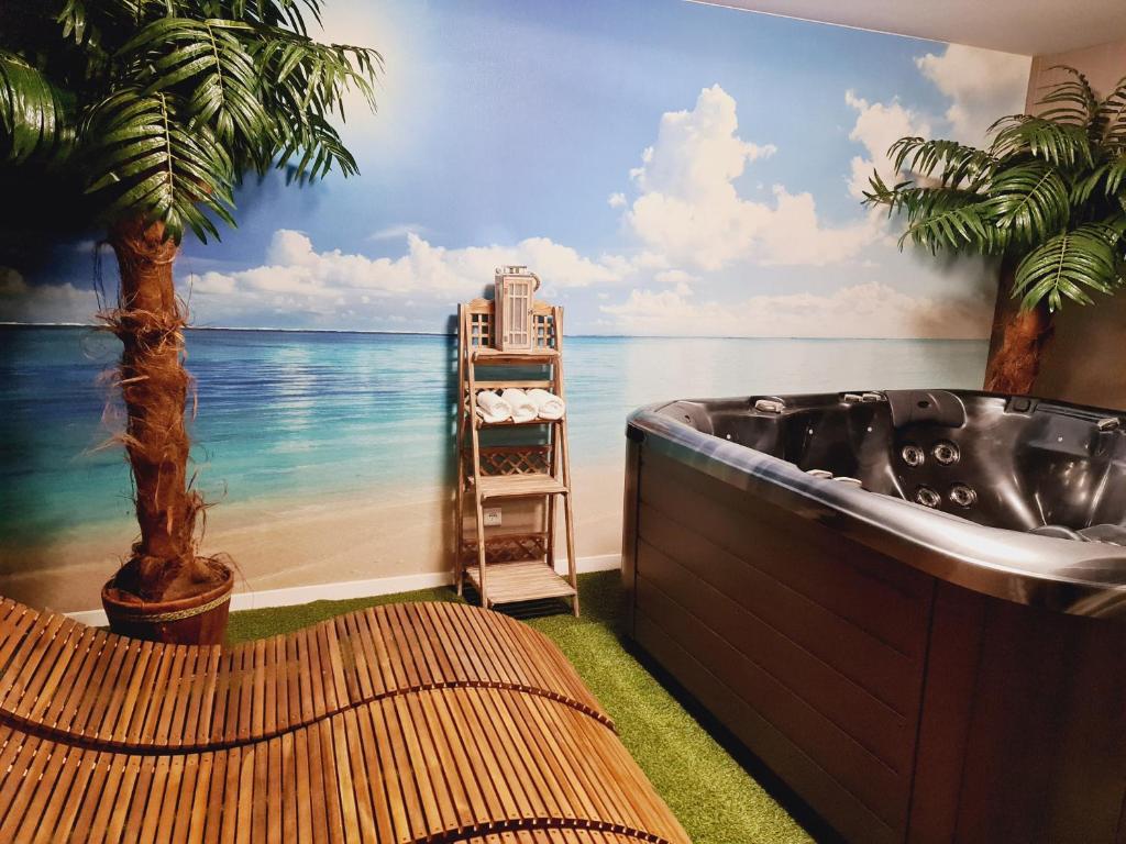 a bath tub in a room with a mural of the ocean at Apartament SPA 56 Resort Kozubnik blisko Szczyrk - 5D Apartamenty in Porąbka