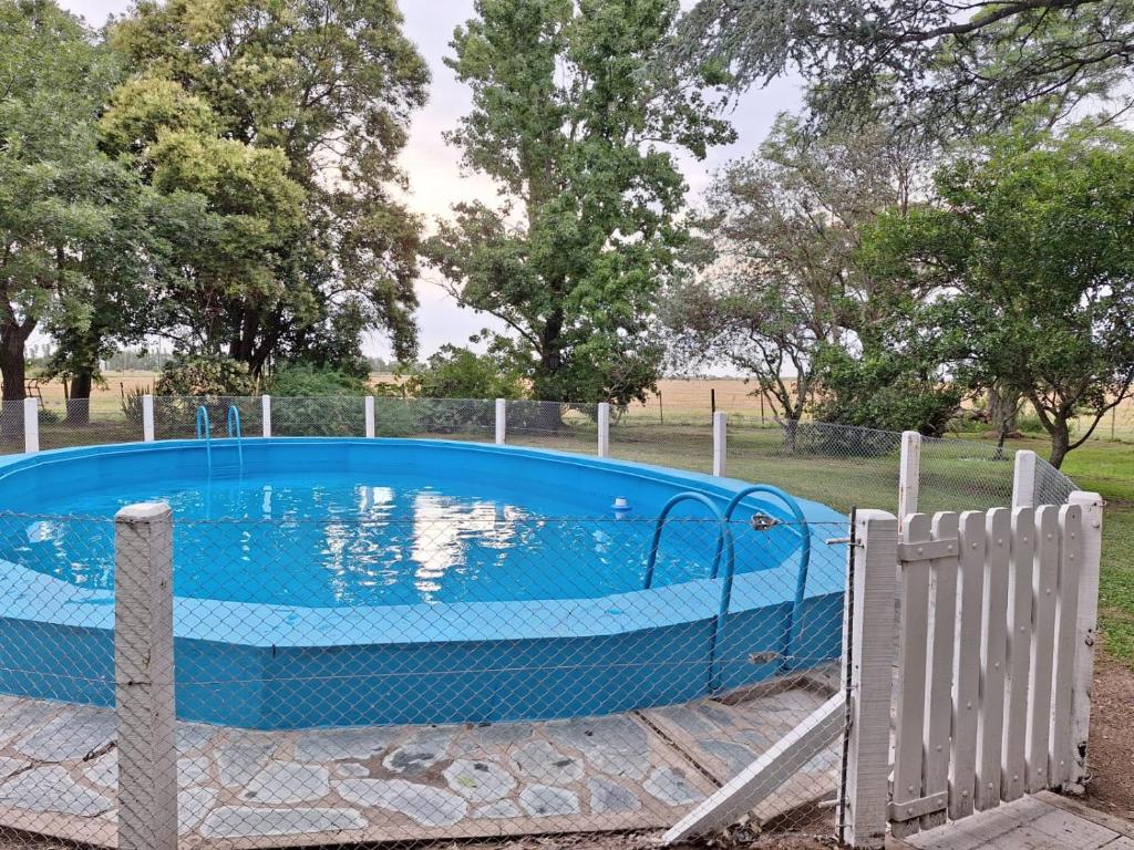 a large blue pool with a fence around it at El Descanso in Villa Lía