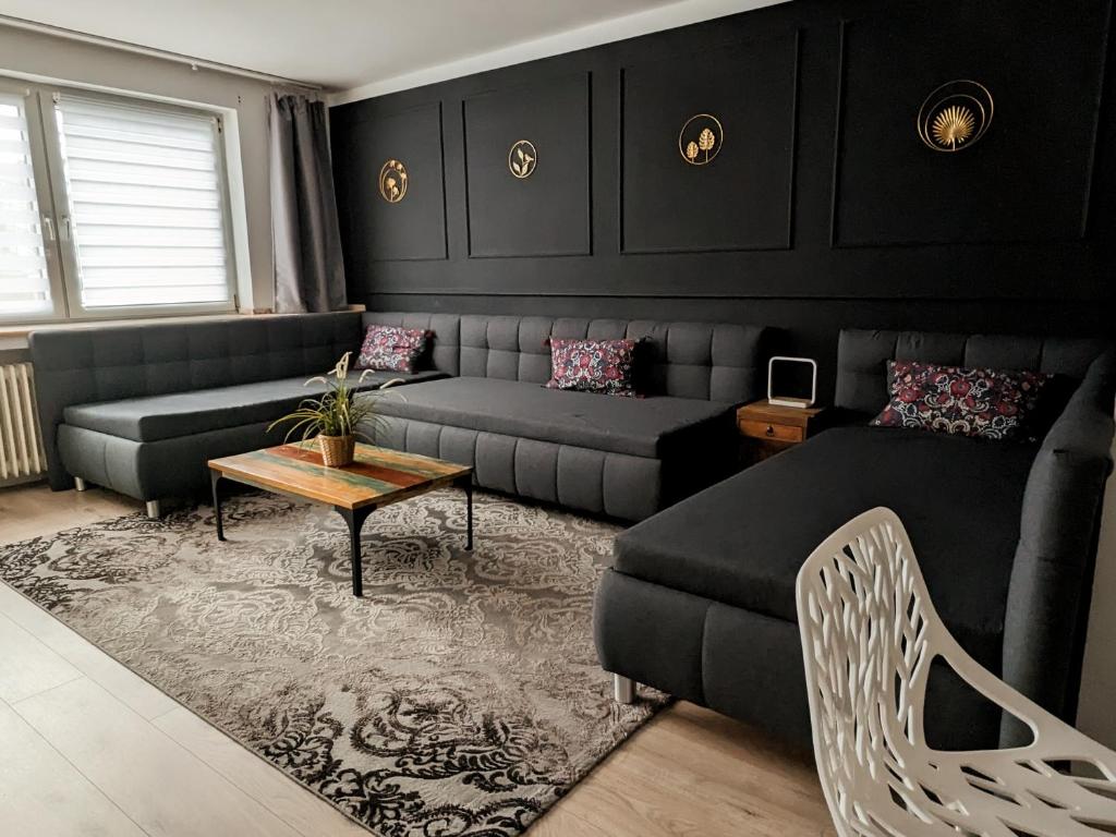 a living room with a couch and a table at Downtown Apartments Unterbilk in Düsseldorf