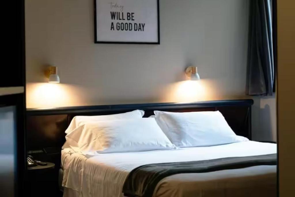 Postel nebo postele na pokoji v ubytování Hotel Concorde