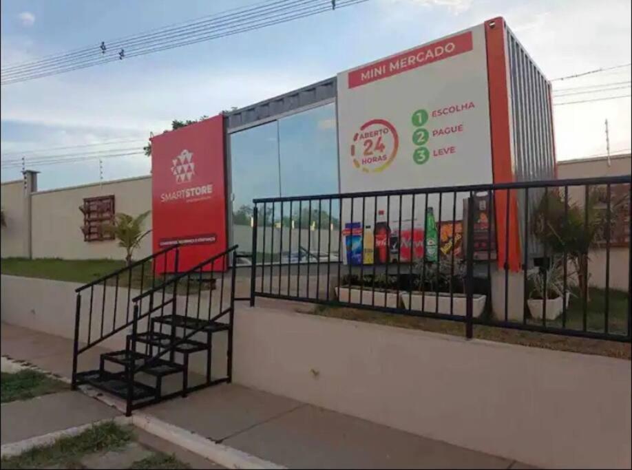 a fence in front of a building with a sign at Apartamento Cuiabá in Cuiabá