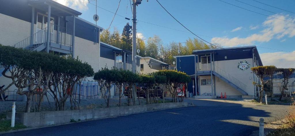 an empty street in front of a building at REBORN相馬 in Soma