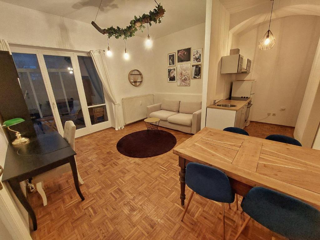 a living room with a table and a couch at Wohnen im Grünen in Graz